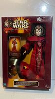 Front of boxed Queen Amidala doll showing figure, gown and accessories
