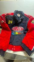 Front view showing DuPont Motorsports logo, #24, red sleeves, ribbed trim