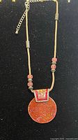 Full necklace showing cord, beads, pendant and extender chain