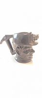 Front left view showing coal miner face, helmet with lamp, handle
