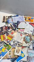 Pile of mixed hockey, game and novelty cards spread on surface