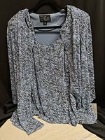 Front view of blue glittery Alex Evenings blouse