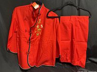 full view of jacket and pants set hung on hangers