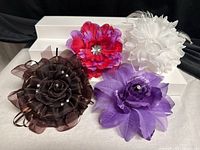 All four fabric floral hair clips arranged together for overall view