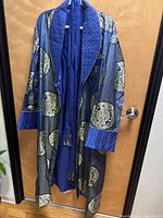 Full view of robe on hanger showing length, pattern and sash