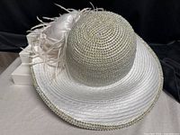 full view of white wide-brim hat with rhinestone crown and brim edge