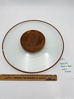 Top view showing full glass platter with teak rim and central teak turntable beside ruler