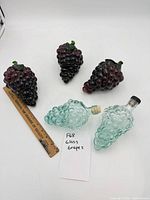 All five glass grape items with ruler and note for scale