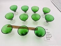 Top view of 11 green glass cocktail/dessert cups showing shape and quantity