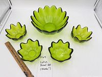 Full set showing one large and four small green lotus glass bowls with ruler for scale