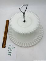 Full view of assembled two-tier milk glass tray with ruler for scale