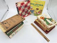 Group shot of all cookbooks showing two stacks and two standing titles