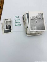 Stack of vintage photos with note card identifying lot