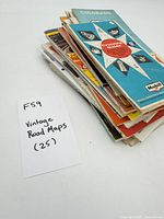 Stack of 25 folded maps