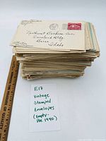 Stack of vintage stamped envelopes with ruler and handwritten note indicating pre-1940