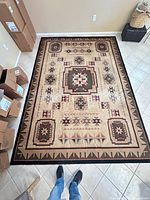 Full view of area rug showing pattern and size relative to tile floor