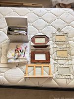 Full lot overview showing frames, card box, fabric, embroidery floss