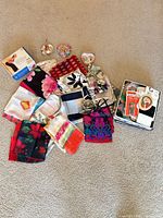 Group shot of scarves, bracelet tin, sewing items and storage tin
