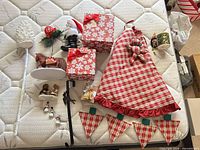 All items laid out: fabric pieces, boxes, figurines, ornaments, mugs, stake, hanger