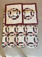 Quilt and two shams laid out showing overall design and colours