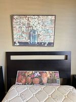 Canvas print mounted above headboard showing floral subject