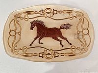 Front view showing horse motif and border