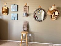 Wide view showing hats, prints, shutter, mirror, stool and hooks