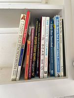 Shelf showing 11 teddy bear books with visible spines