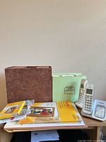 Overall lot showing accordion file, Home Filer box, Kodak paper packs, Panasonic phones