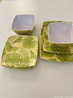 Square bowls and plates with green leaf pattern