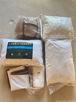 All six bedding items in original plastic packaging displayed on carpet