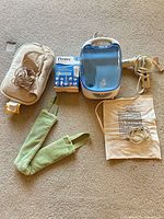Group shot of all items: humidifier, hair dryer, two heating pads, neck wrap, Protec filter