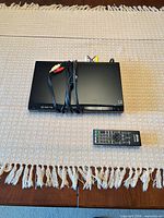 Front view of Sony DVD player with bundled cables and remote