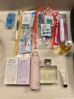 Assorted dental items, fragrances, lotions on counter