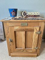Front view of White Clad cabinet with decor items on top