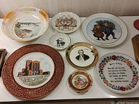Group image of thirteen assorted plates and bowls