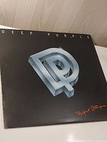 Front album cover with DP metallic logo and title