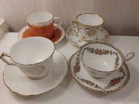 Group shot of the four teacup and saucer sets