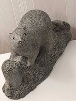 Front angled view of Wolf Originals stone beaver sculpture on log