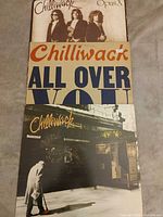 Front jackets of three Chilliwack vinyl LP albums: Opus X, All Over You, self-titled street-scene cover