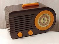 Front view showing grille, dial, knobs