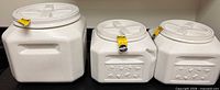 All three containers side by side showing relative sizes and lids