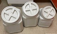Three Gamma Vittles Vault containers, two large, one smaller, all with lids attached