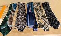 All five Jerry Garcia ties hanging side by side on rack