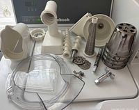 Group shot of all KitchenAid attachment parts on surface