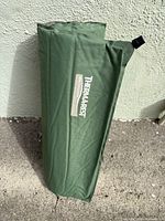 Green Therm-a-Rest sleeping pad rolled