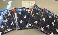 Four sealed American flags with embroidered stars packaging