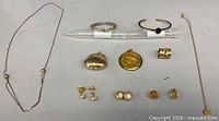Overall view of all 10 jewelry pieces laid out for identification
