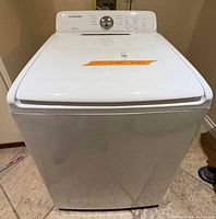 Front and top view of washing machine showing overall condition and rust on base
