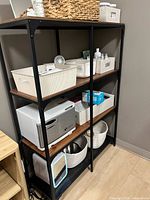 full view of black metal mesh desk organizer on shelving unit
